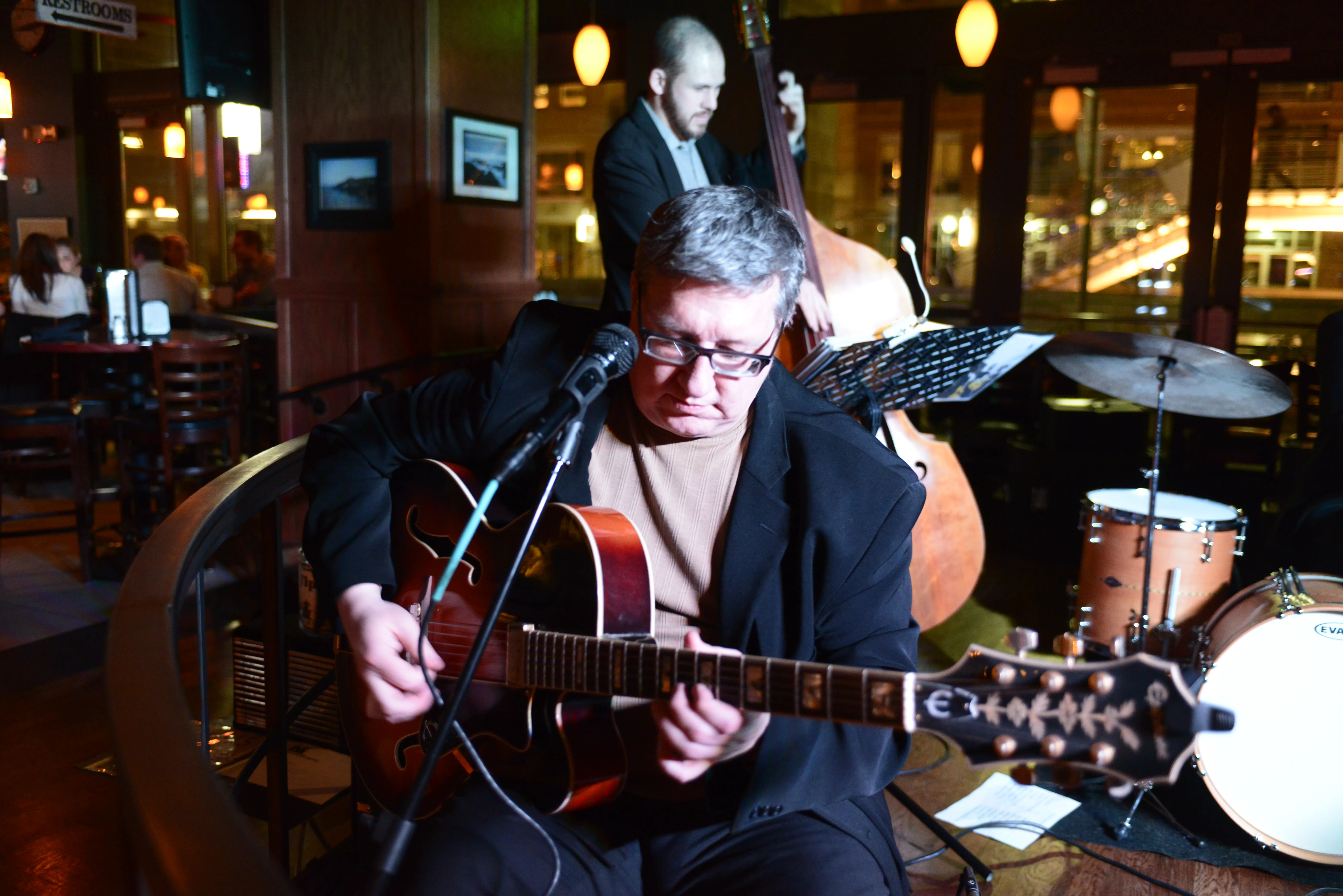 Elliot Reed sitting, playing Epiphone guitar in Slattery's nightclub,